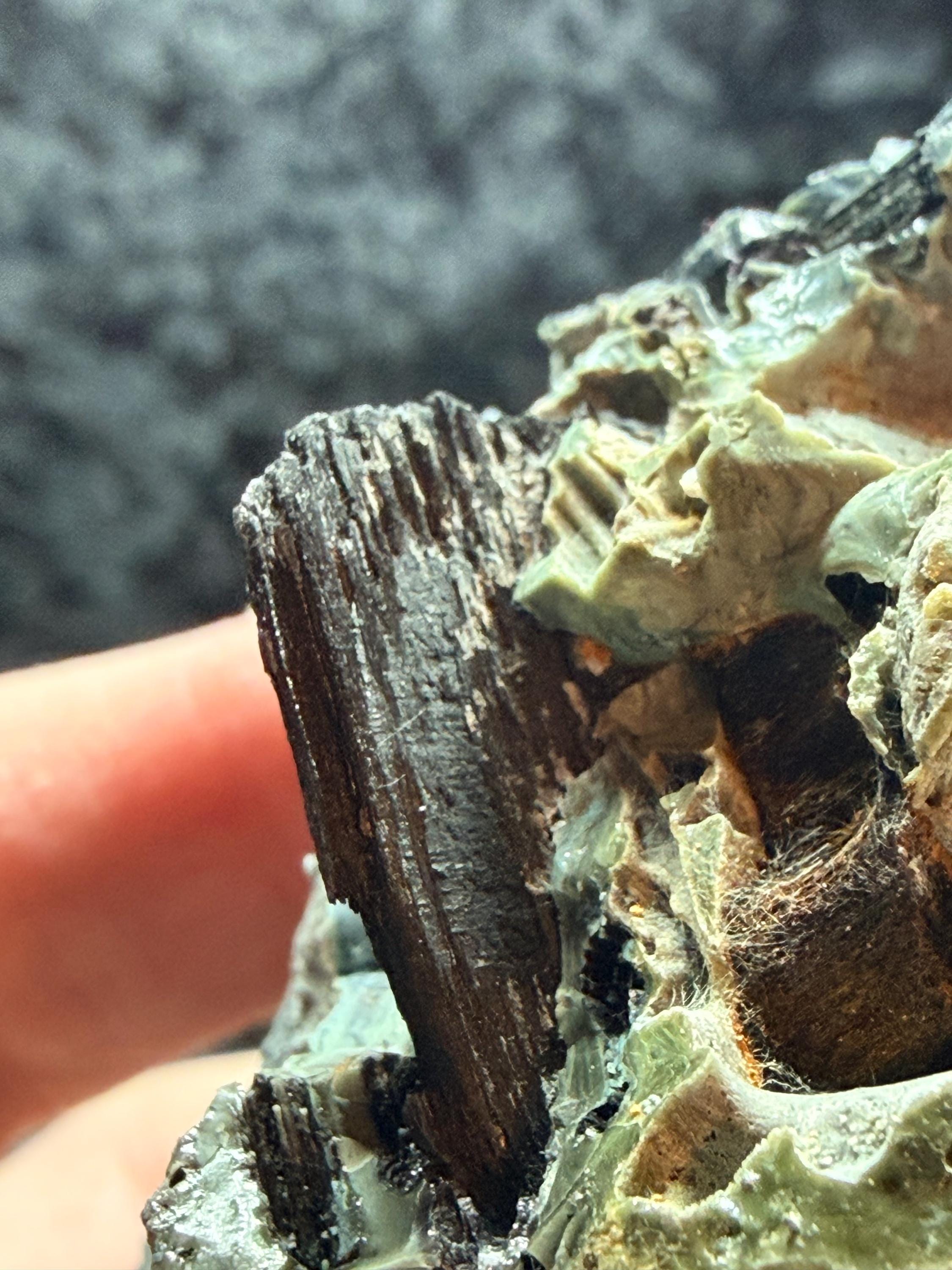 Blue swirl slag glass with coal embedded.