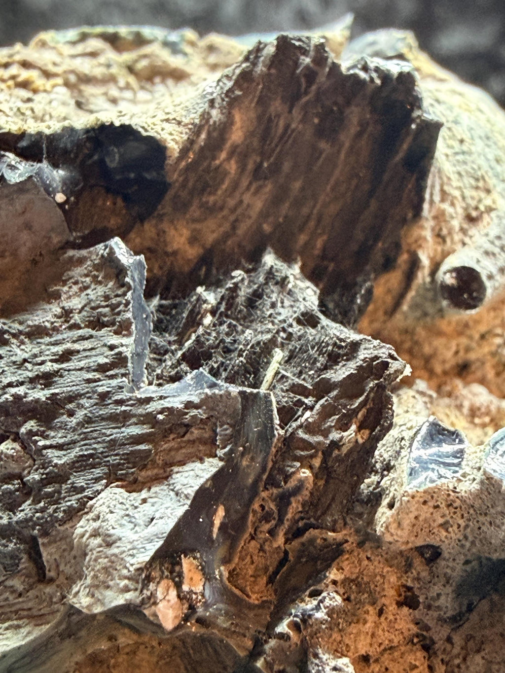 Blue swirl slag glass with coal embedded.