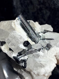 Blue and black tourmaline on quartz with calcite and Muscovite