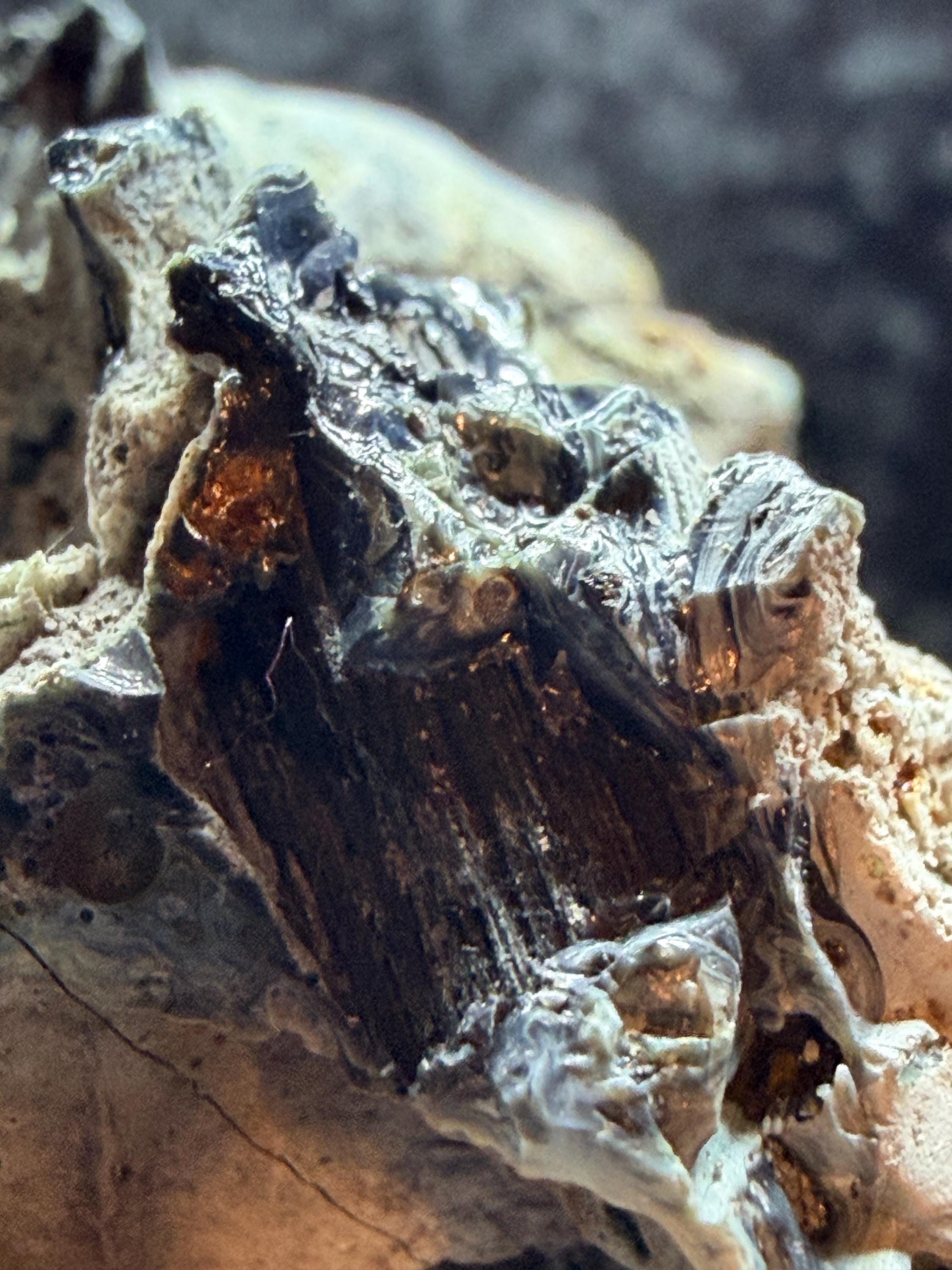 Blue swirl slag glass with coal embedded.