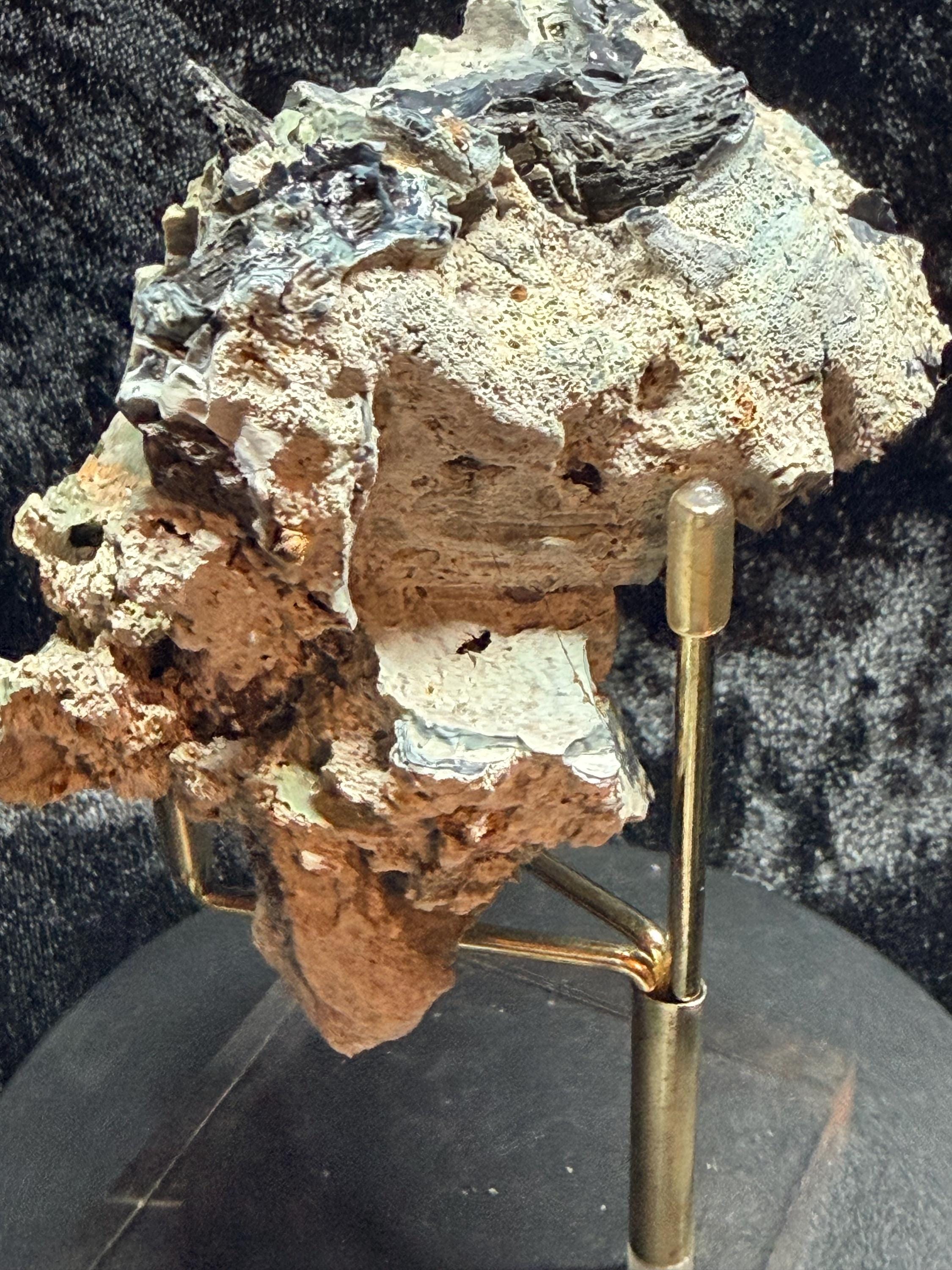 Blue swirl slag glass with coal embedded.